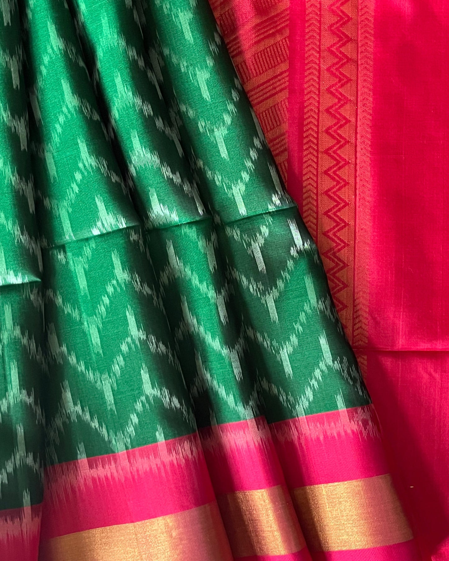 Close-up of silver chevron ikat on emerald soft silk