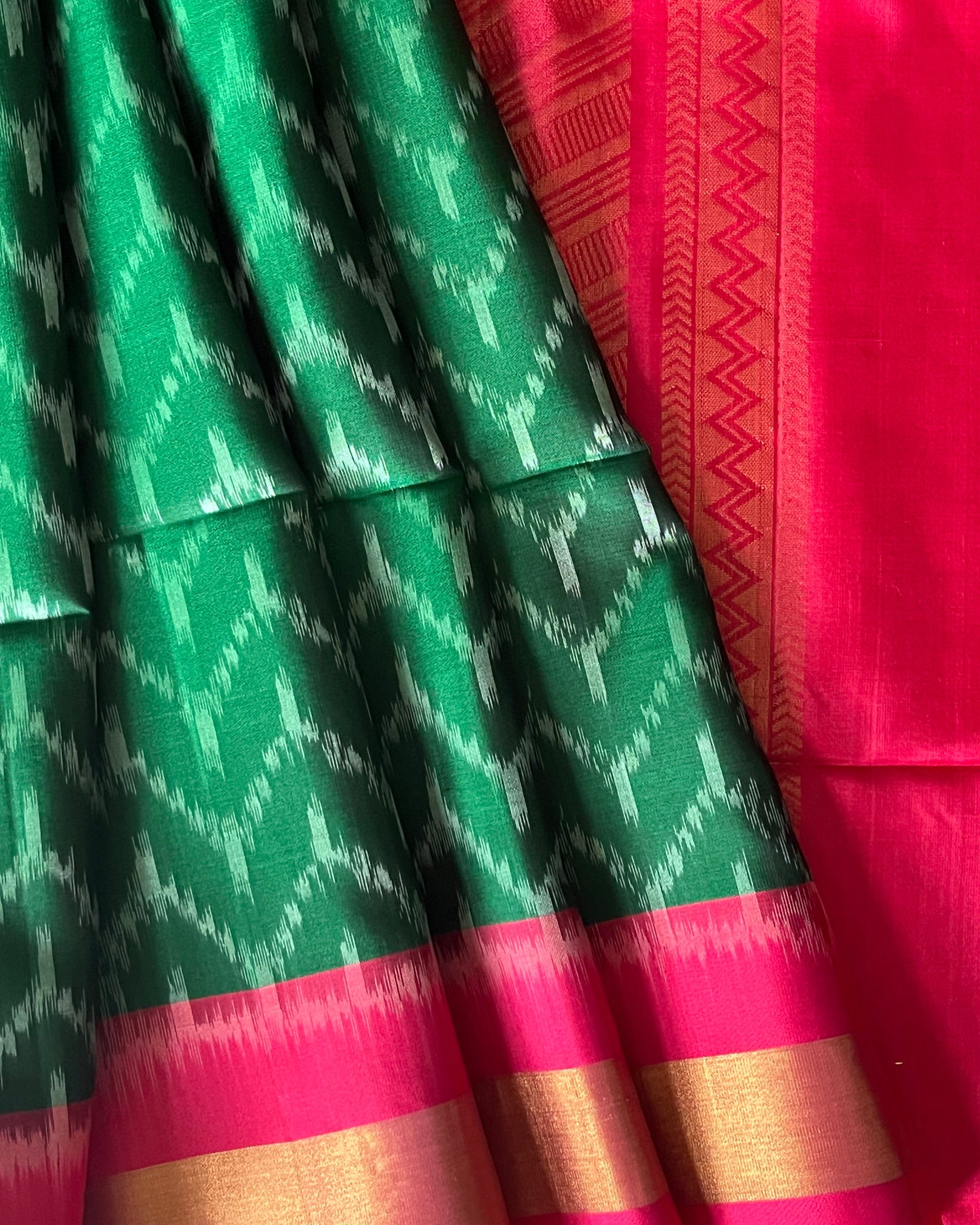 Close-up of silver chevron ikat on emerald soft silk